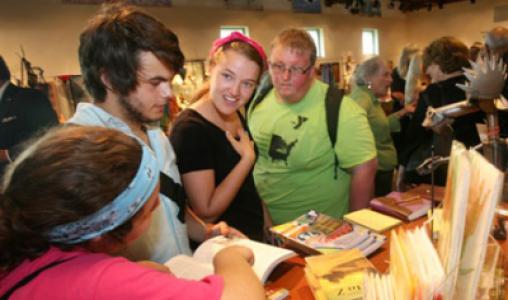 3 Young Visitors Check Out The Book Selections At The Center