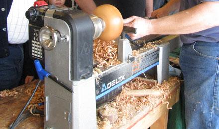 6 Richard Adams Demonstrates Woodturning On A Lathe For Visitors